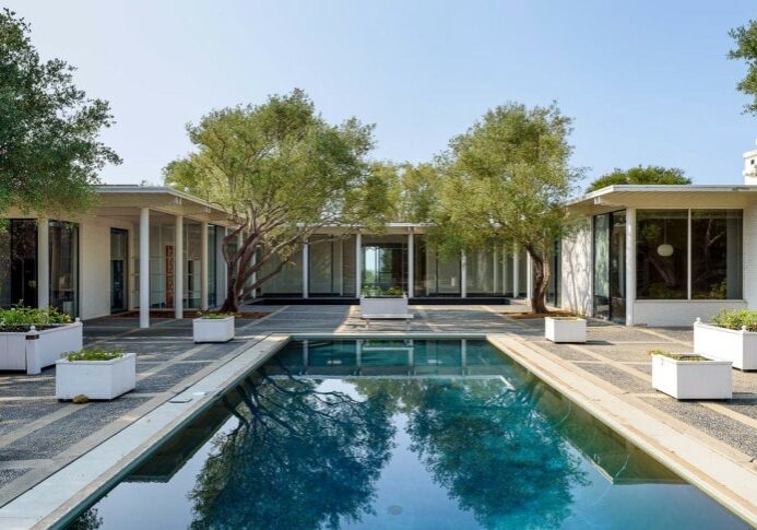 A rare midcentury modern architectural offering in the heart of Montecito, The Erving House, described as a “glass tent” by Time magazine in 1951,is a singular expression of architectural and landscape mastery, gracefully nestled on 2.7 acres of private, artfully curated grounds. Designed in 1950 by renowned architect Lutah Maria Riggs during her iconic modernist phase, and complemented by the legendary California landscape architect Thomas Church, this estate exemplifies the essence of indoor-outdoor living.